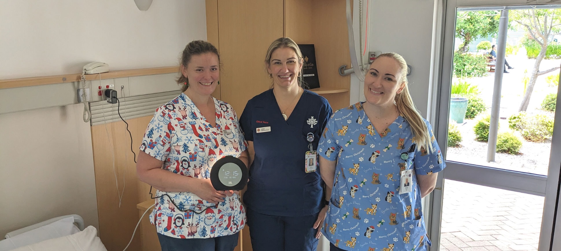 Maeve O’Malley (Acting Nurse Unit Manager), Dana Cederman (Clinical Nurse), and Kirsty Bright (Registered Nurse) installing new digital radios in palliative patient rooms.