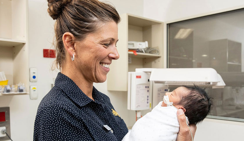 Caregiver holding newborn baby