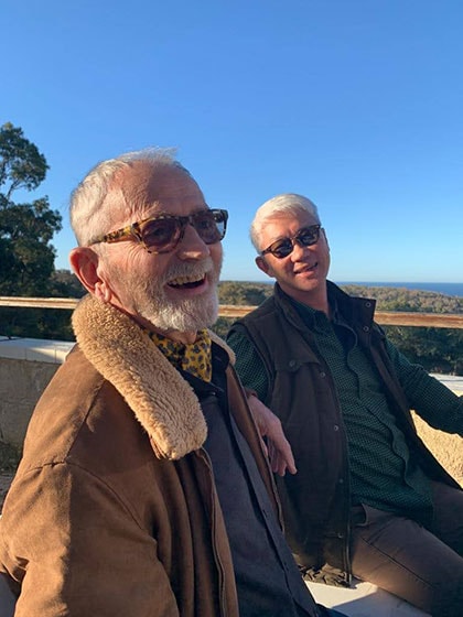 Dennis and Peter sitting at a lookout point with a view