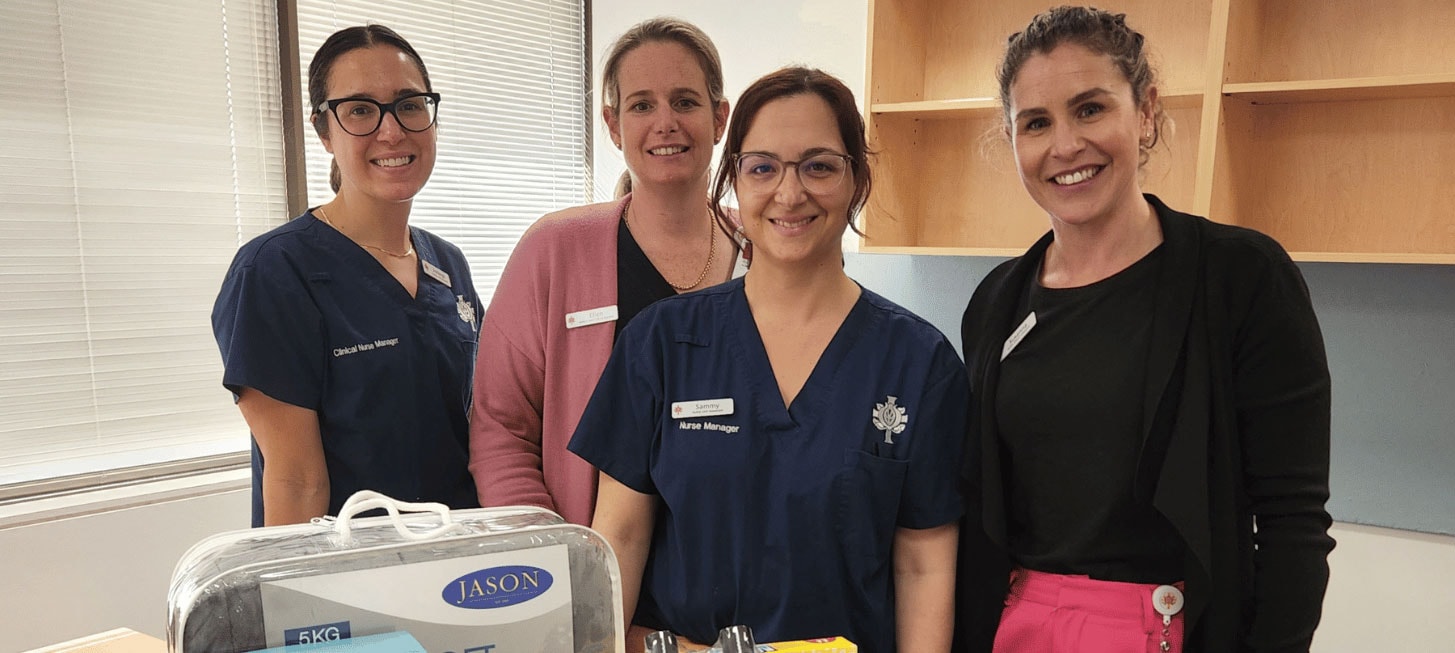 Four smiling female caregivers