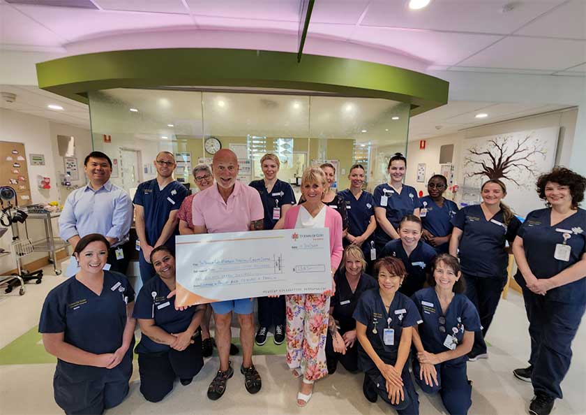 Eleanor Roderick and St John of God Murdoch Hospital Cancer Centre staff pose with a giant cheque for $2,587