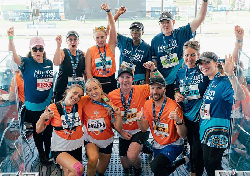 St John of God Foundation team hold their arms up in celebration at completing the HBF run for a reason