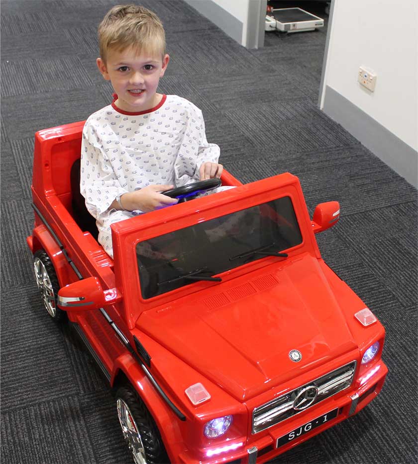A young child patient enjoying the remote control car