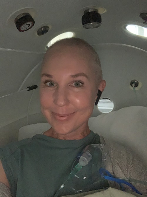 Sam smiles as an oxygen mask lays beside her.