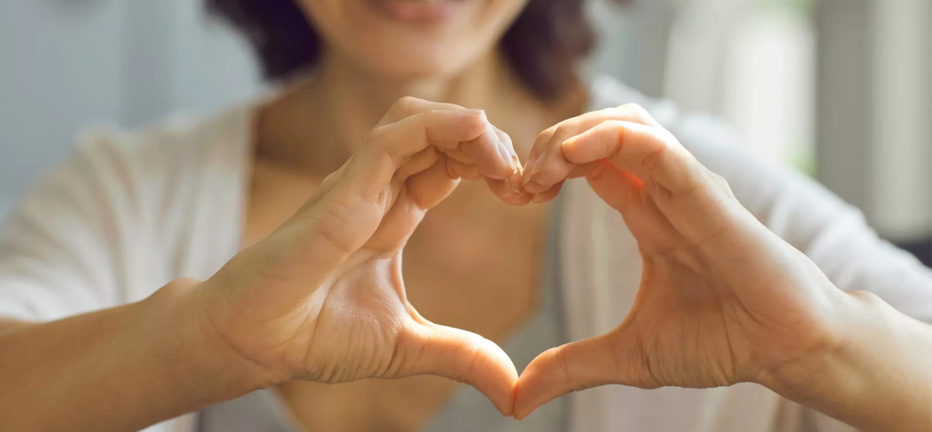 2 hands coming together to form the shape of a heart