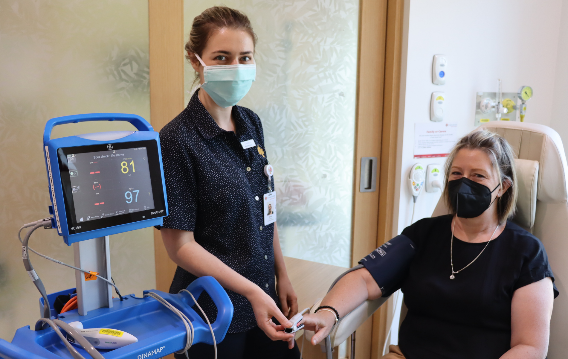 Patient and caregiver using ECG machine