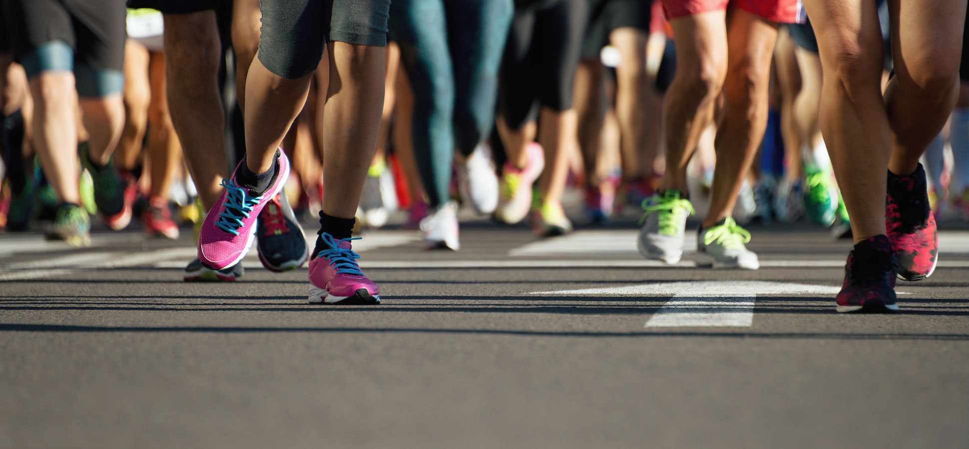 Runners feet running on road