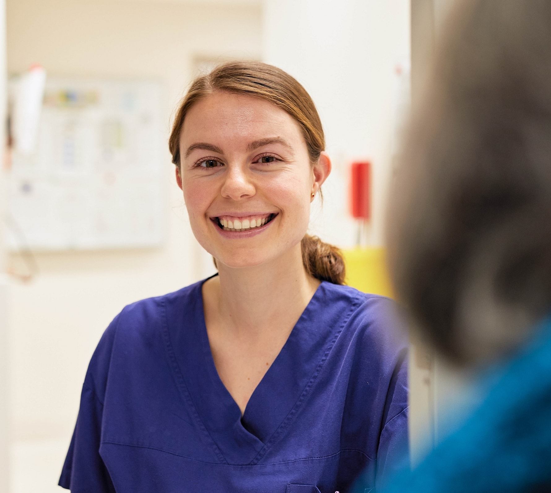 Smiling hospital caregiver in scrubs