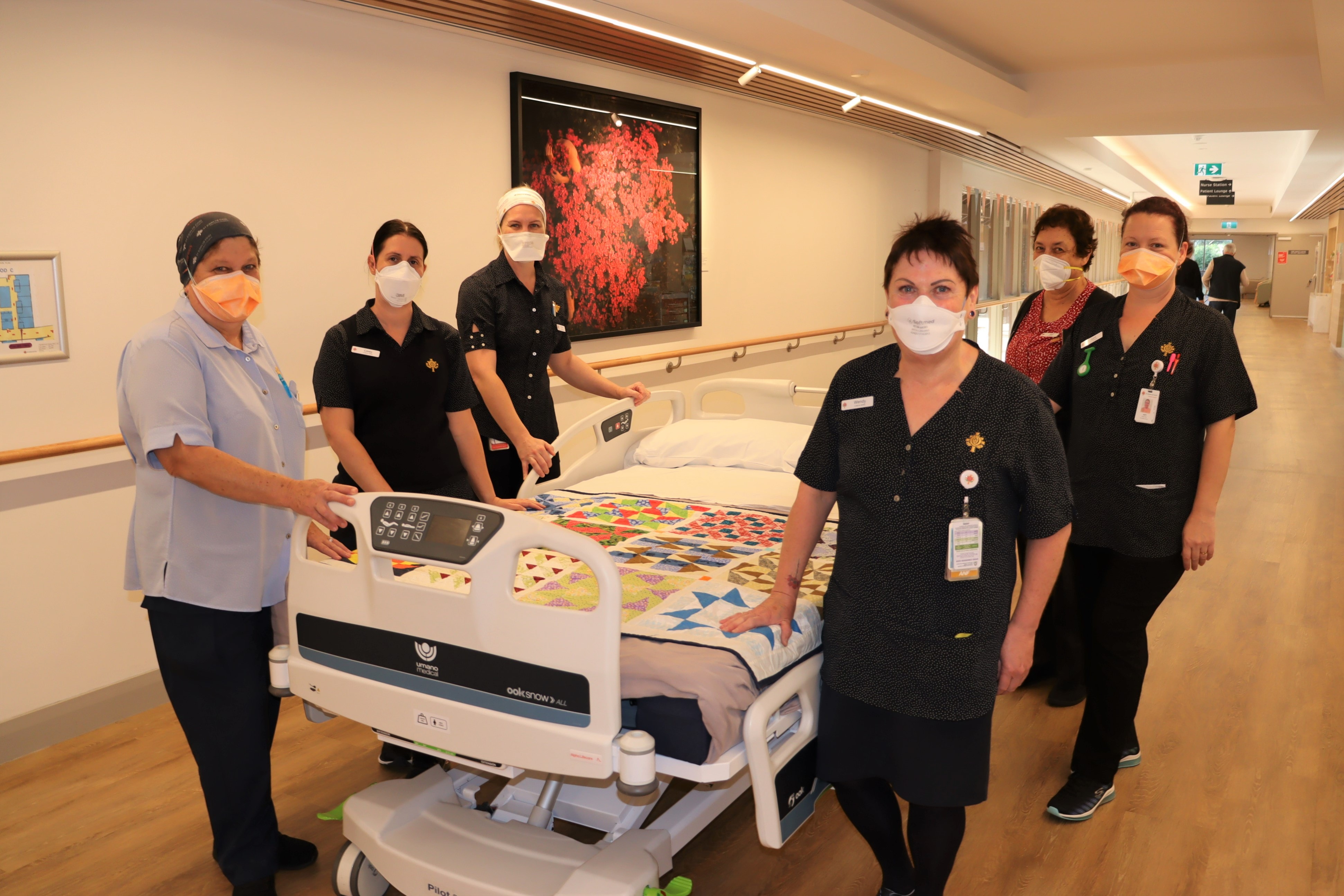 St John of God Murdoch Hospital caregivers standing next to a Cuddle Bed