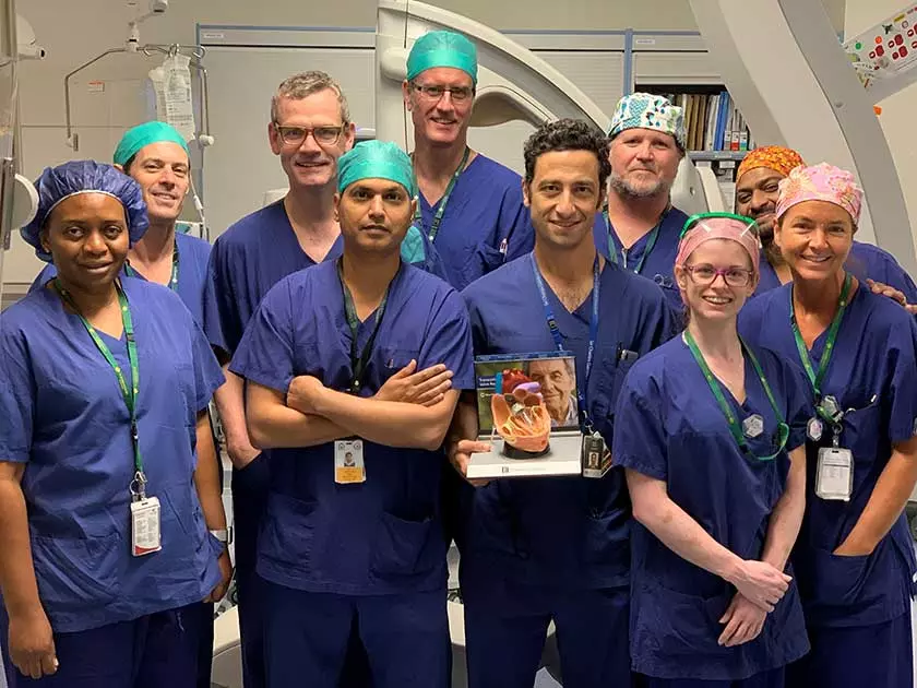 TAVI team which performed the 50th procedure, standing in scrubs in the cath lab.