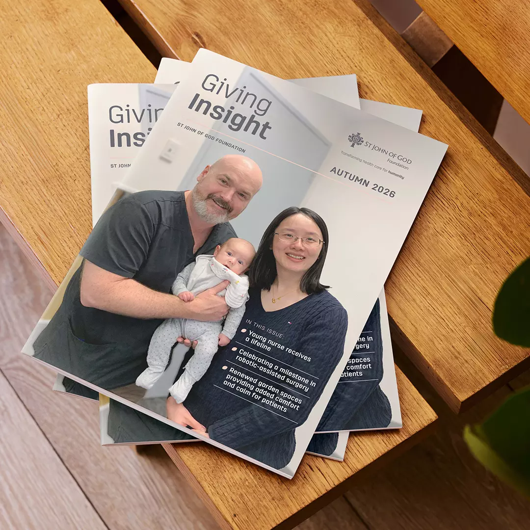 3 magazines with the title “Giving Insight 2026” lying on a brown wooden table.