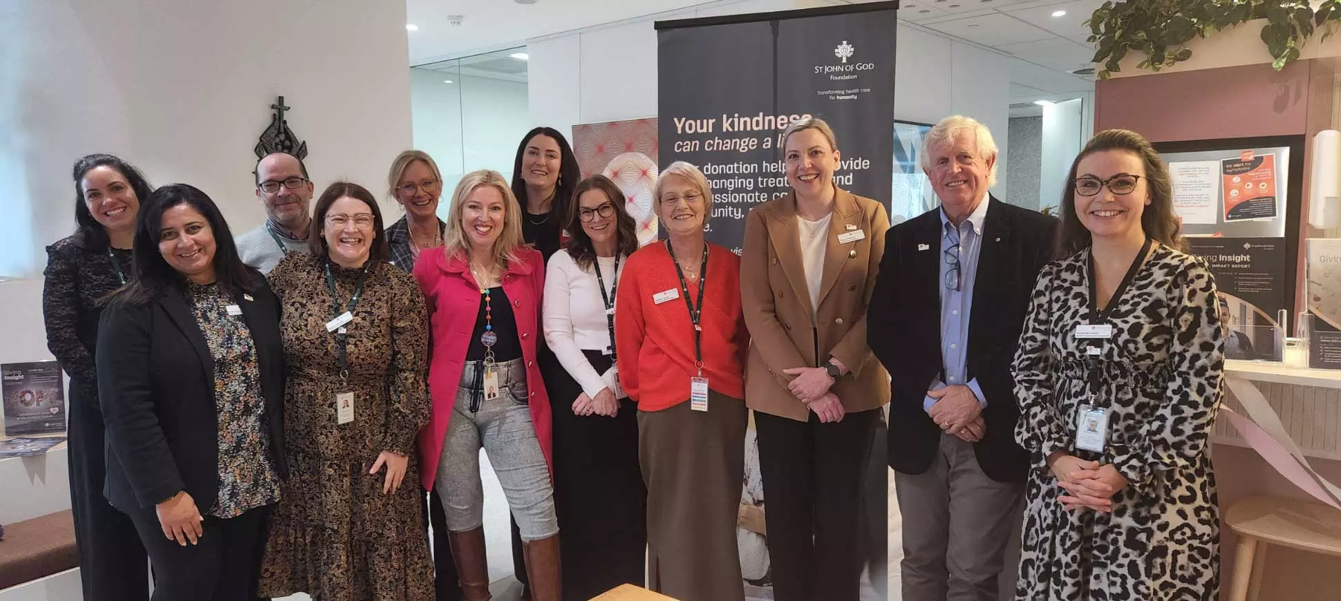 12 of the St John of God Foundation team smile for a photo.