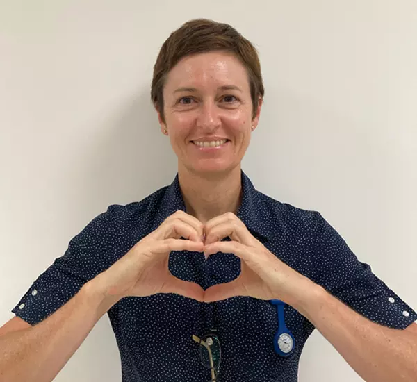 Caregiver with love heart hands.