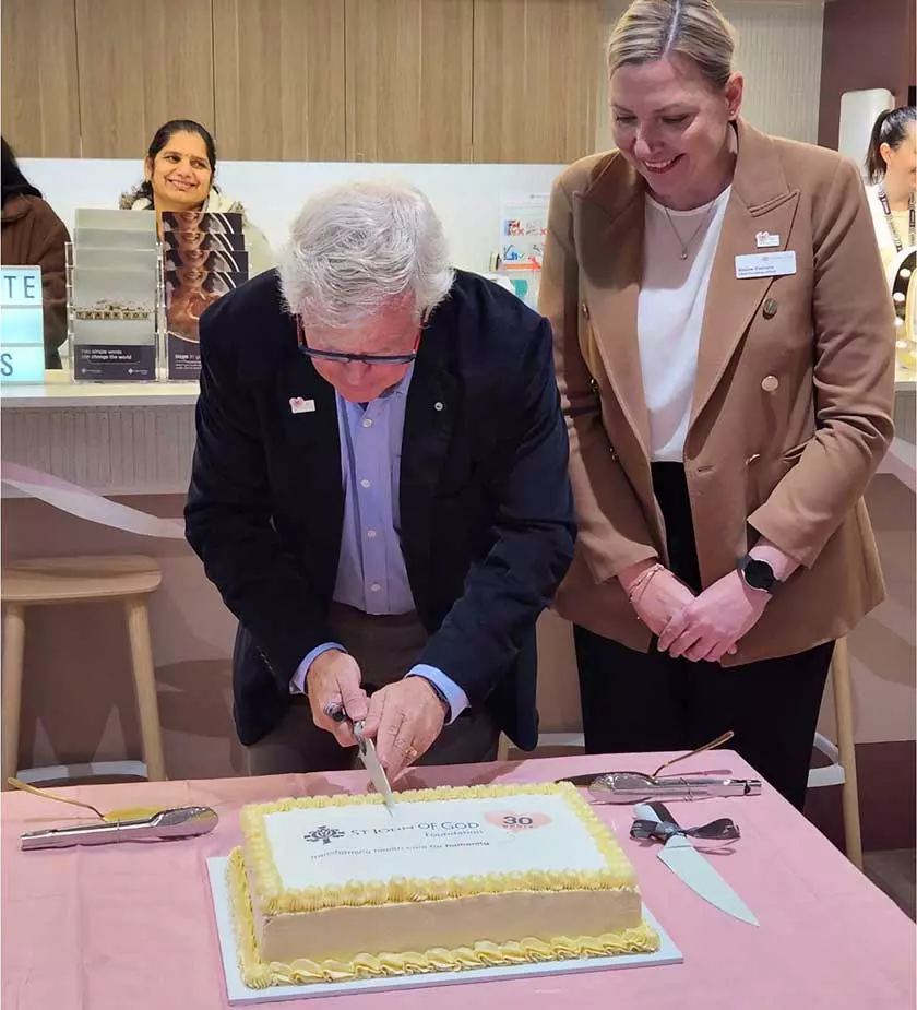 St John of God Foundation Board Chair Tony Howarth AO and CEO Bianca Pietralla cut the cake.