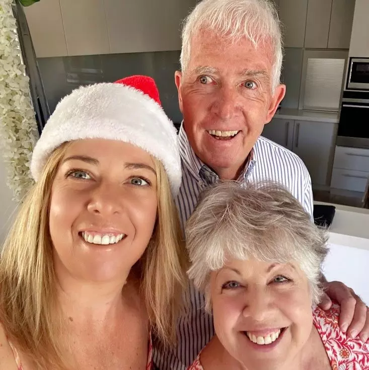 Image of Pauline Tew and family smiling on Christmas day.
