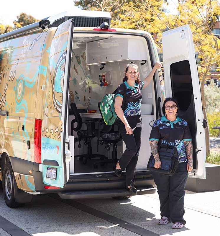 Two caregivers with MBM van